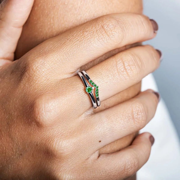 Yellow gold and emerald ring worn on the ring finger, a symbol of commitment and elegance