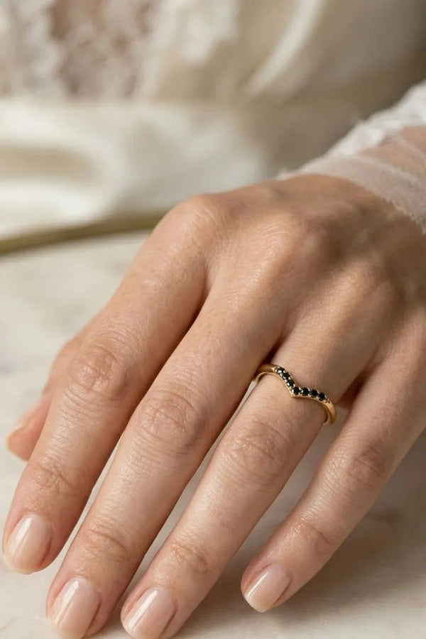 Mayuri black diamond engagement ring worn on a woman's hand