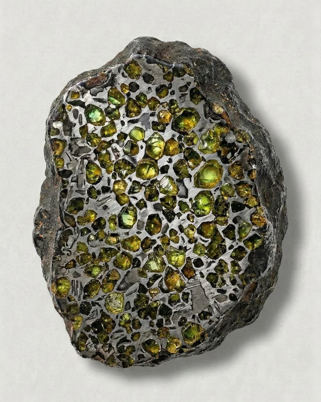 Olivine (peridot) crystals within a pallasite meteorite, an extraterrestrial gem dating back 4.5 billion years