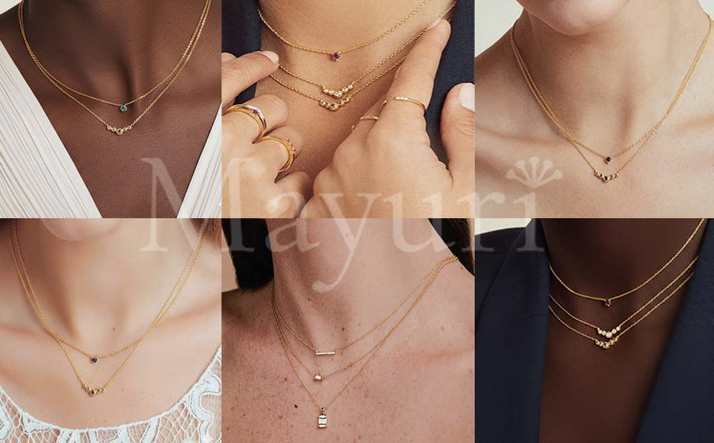 Delicate 18K gold necklaces adorned with coloured gemstones, sapphire, emerald and ruby, layered on fair and olive skin
