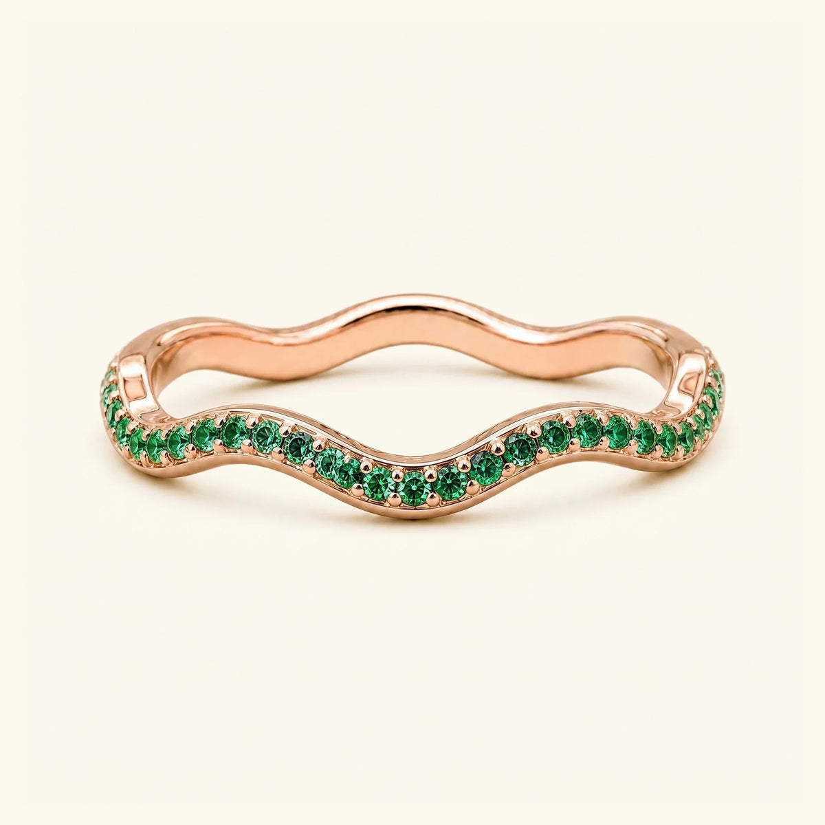 Thalassa wave wedding ring with emeralds in 18K rose gold, half-eternity pavé set