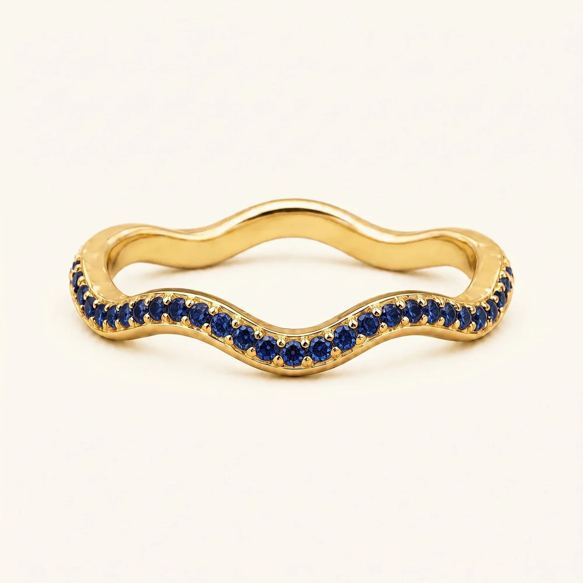 Thalassa wave wedding ring with sapphires in 18K yellow gold, half-eternity pavé set