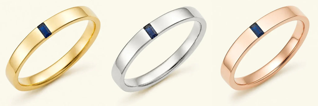 The Agni men's engagement ring in 18K yellow gold, white gold, and rose gold, set with a baguette cut sapphire