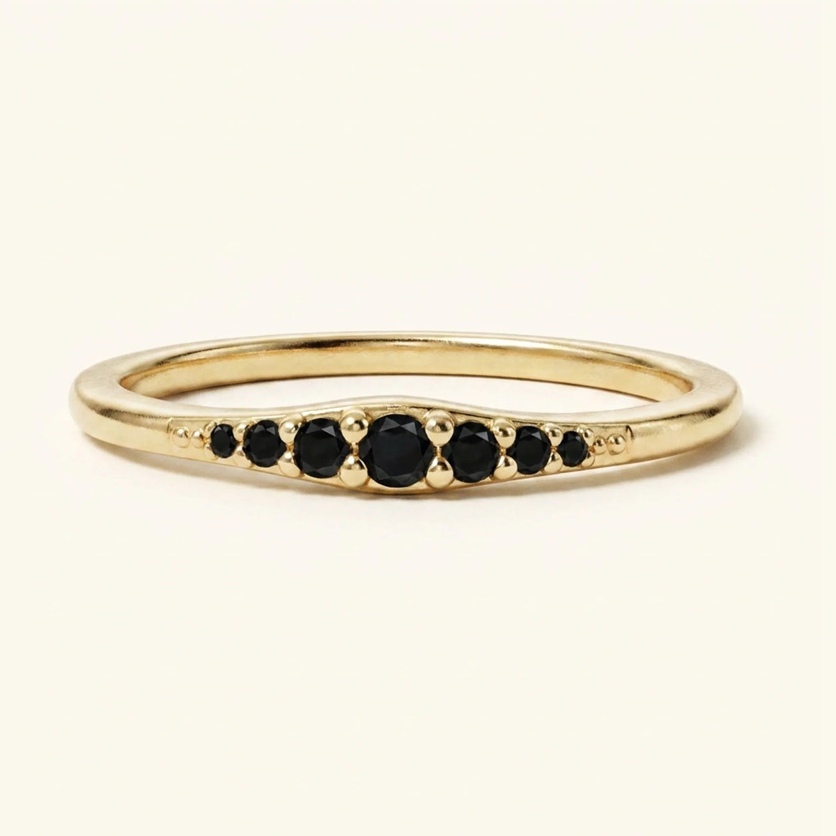 Yellow gold Sushma ring set with 7 black diamonds