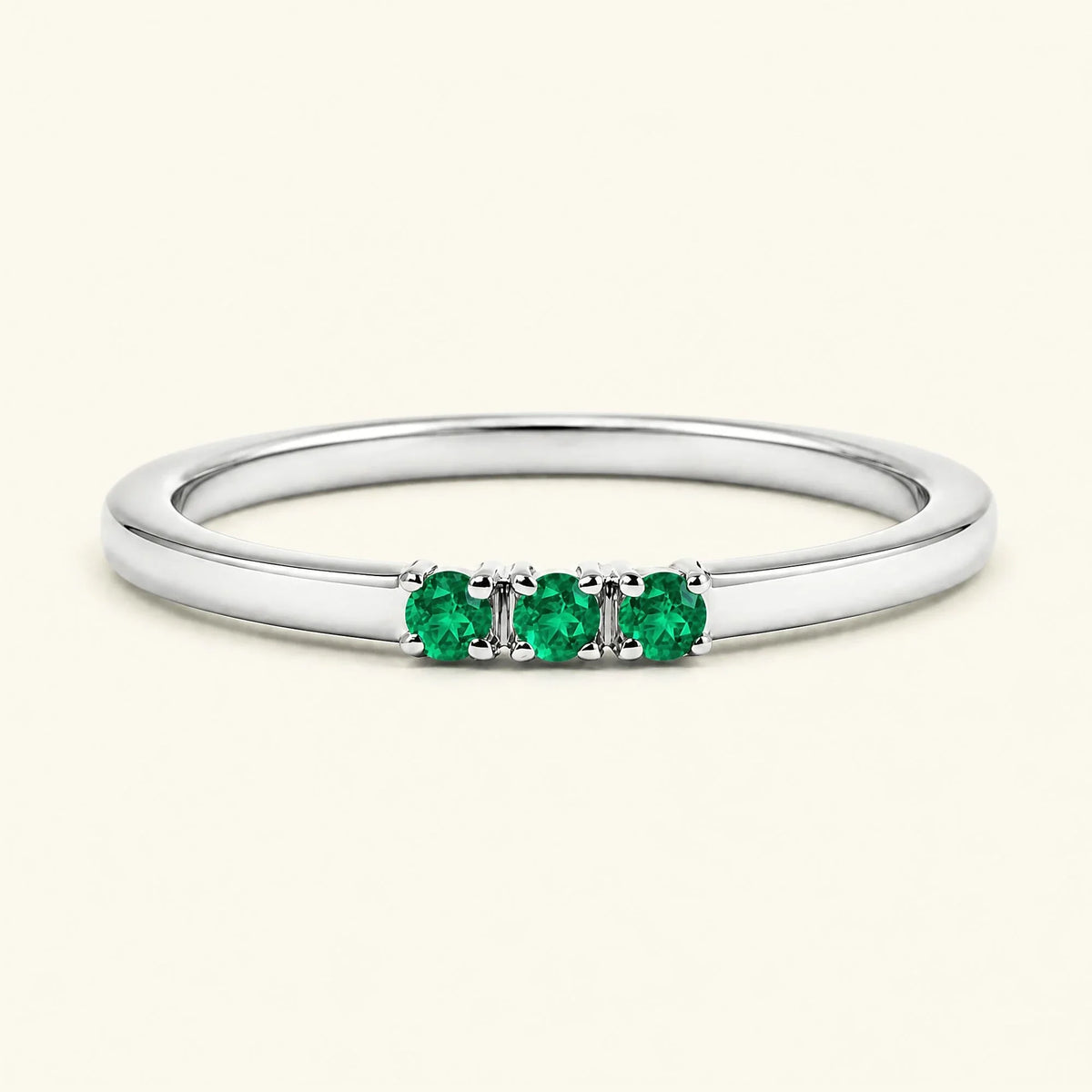Emerald trilogy engagement ring in white gold