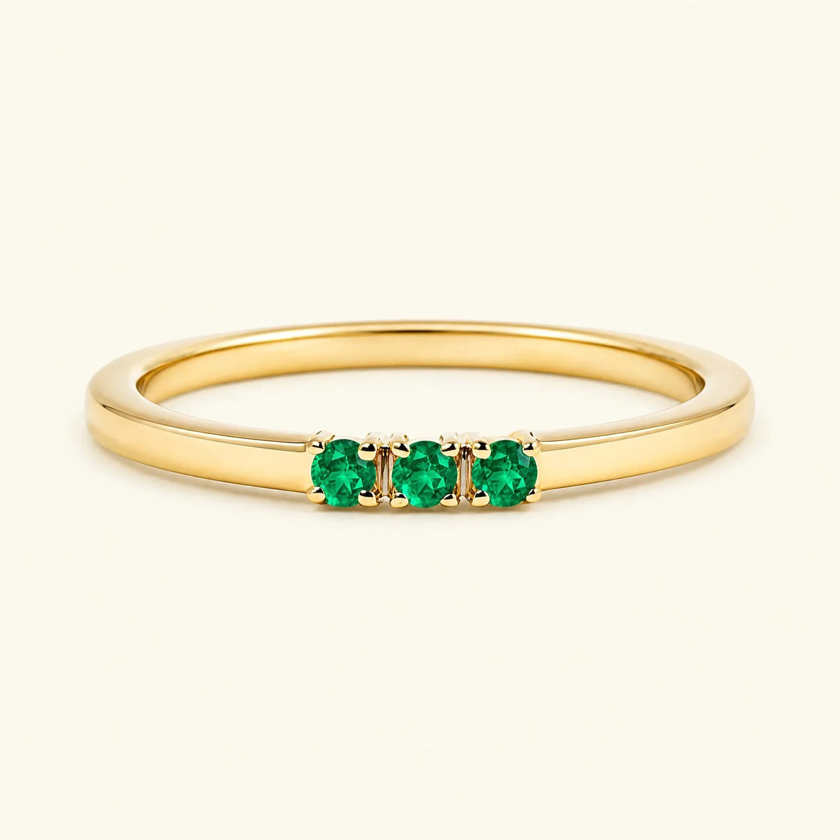 Emerald trilogy engagement ring in yellow gold
