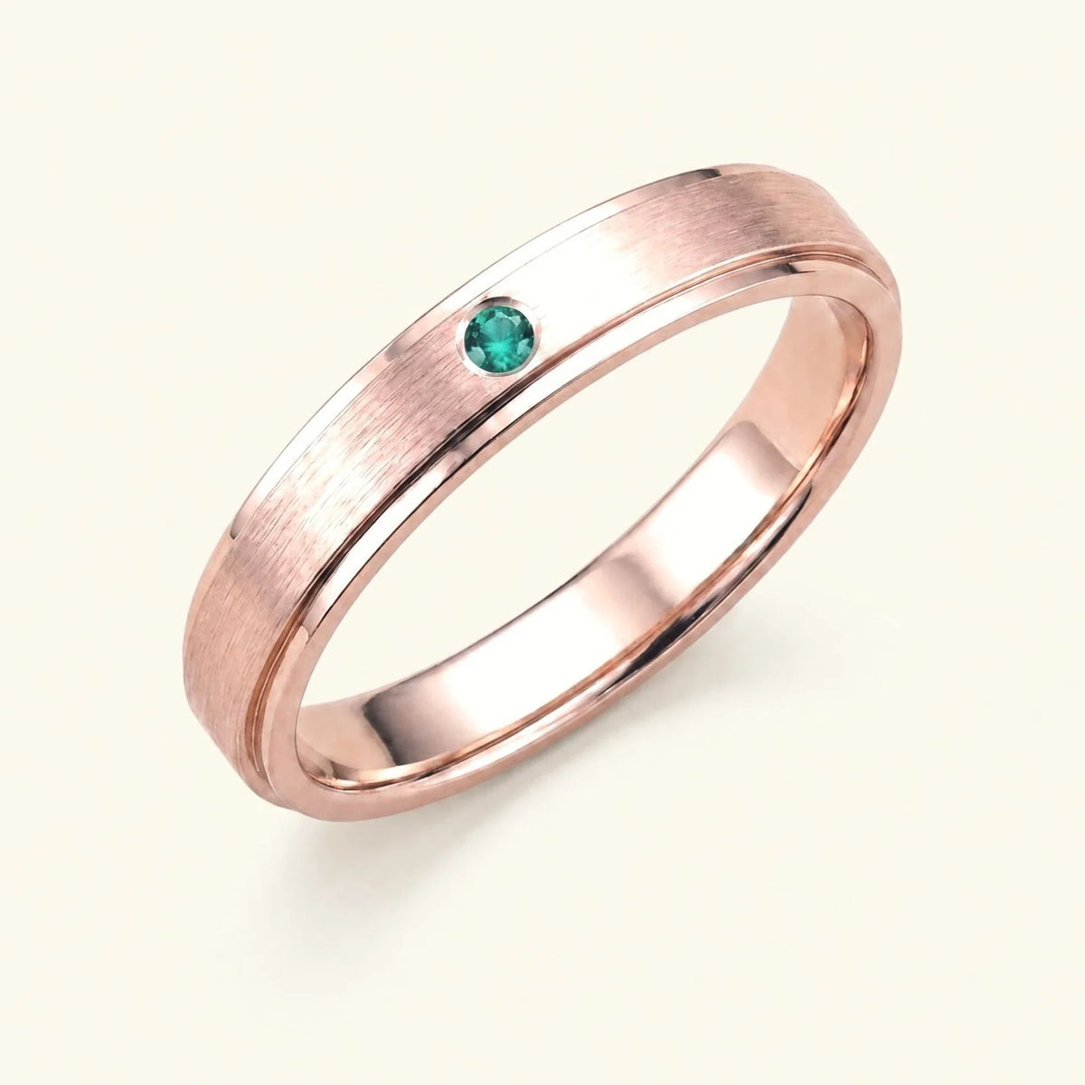 Dhruva emerald wedding band in 18k rose gold, brushed band bezel setting