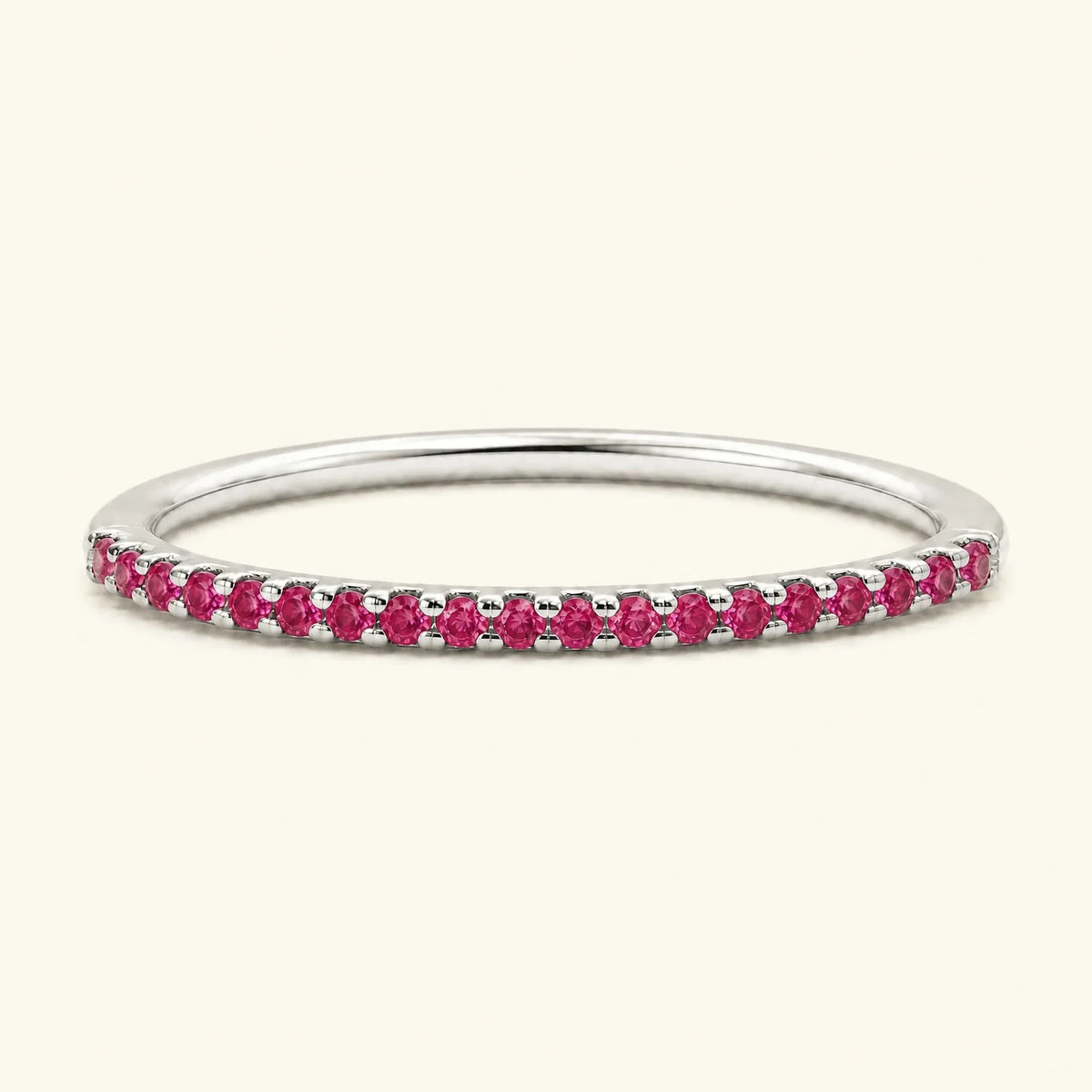 Eternity wedding ring half-way pavé set with rubies in white gold