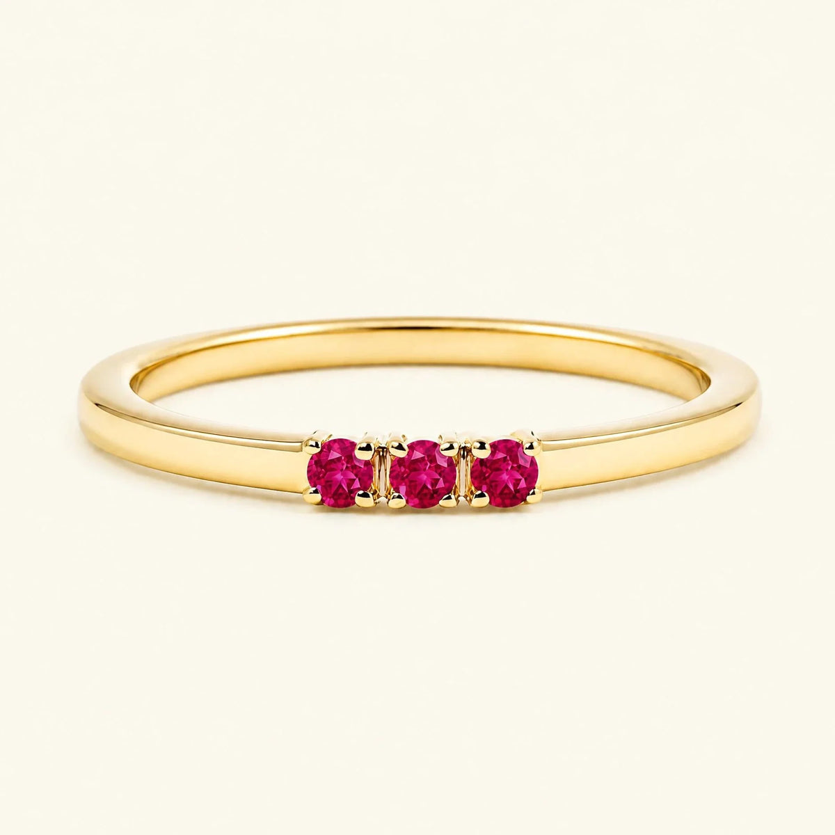 Ruby trilogy engagement ring in yellow gold