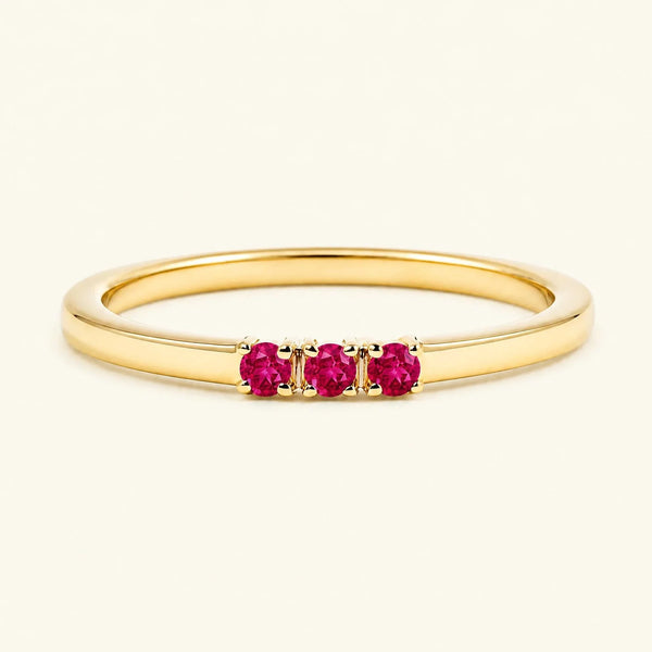 Ruby trilogy engagement ring in yellow gold
