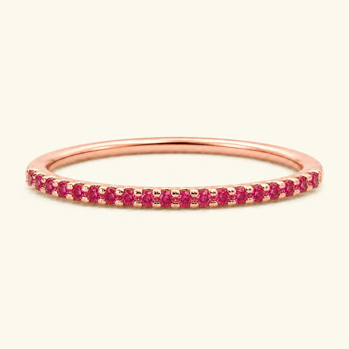 Half-way eternity wedding ring pavé set with rubies in rose gold