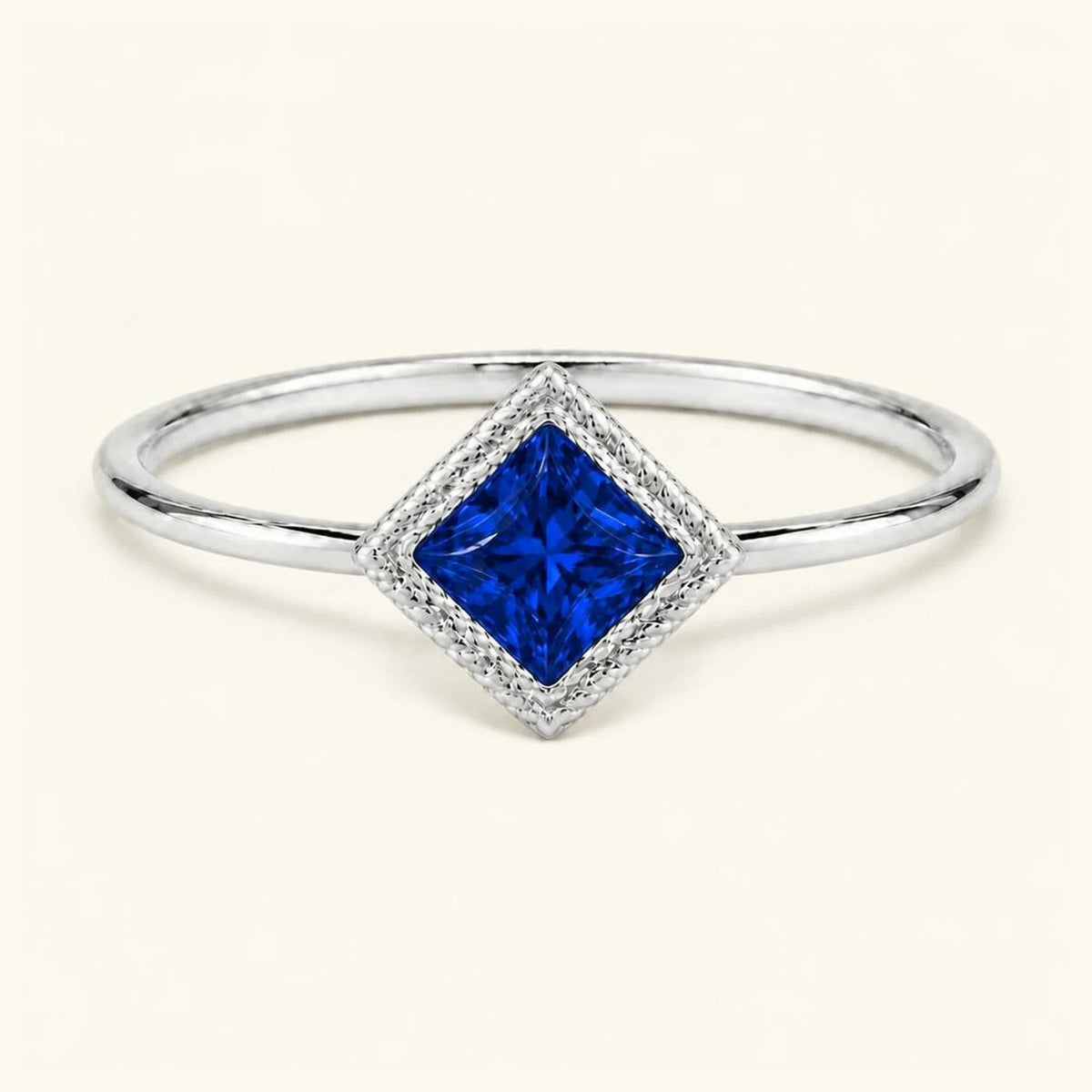 Vintage Indrani engagement ring — sapphire solitaire princess cut 4 mm, square stone in twisted rope setting, 18K white gold