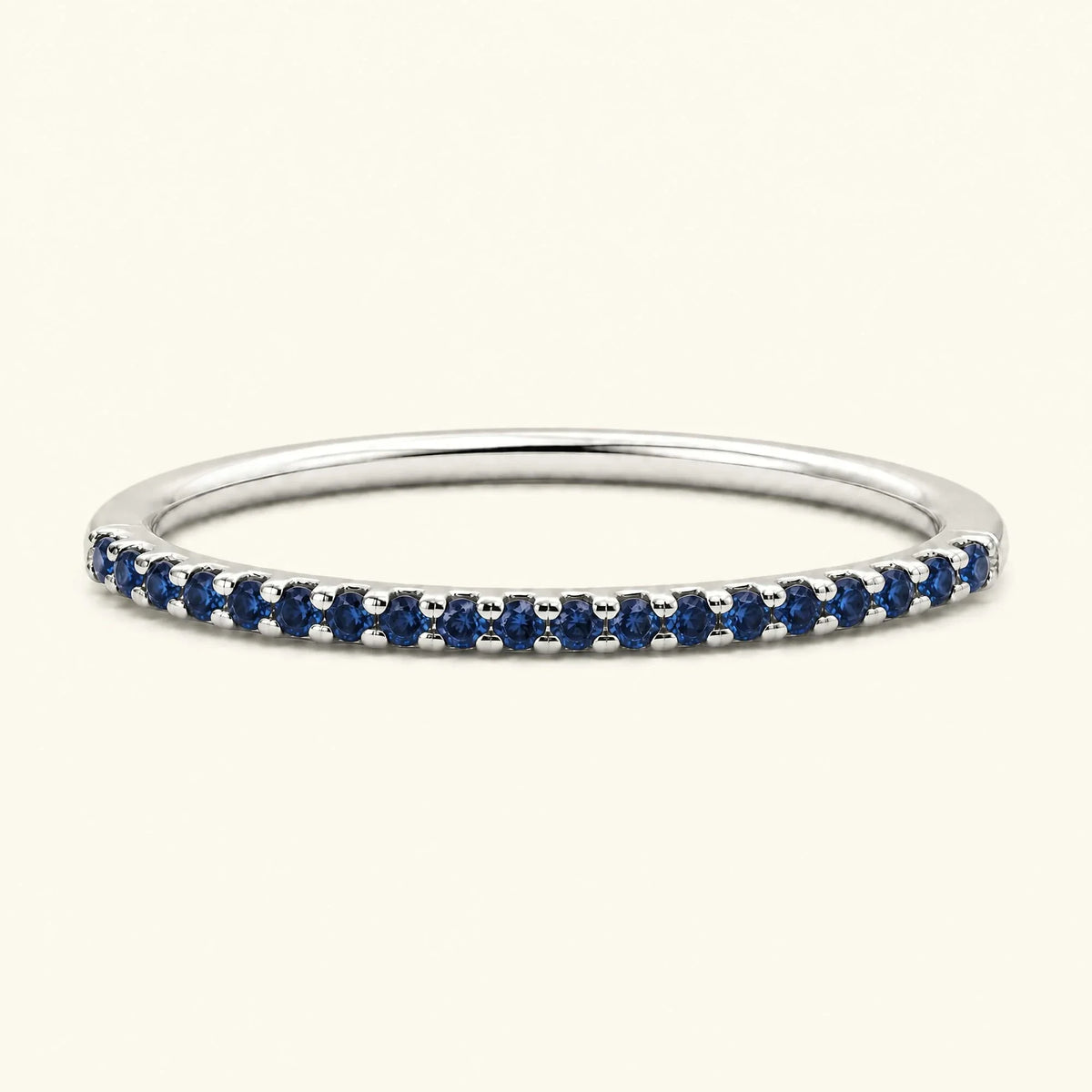 Eternity sapphire ring half-way pavé set in white gold