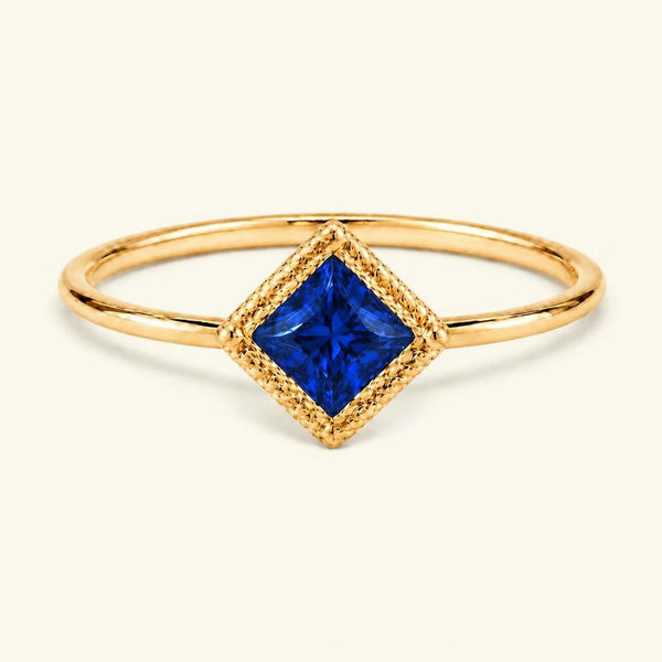 Vintage Indrani engagement ring — sapphire solitaire princess cut 4 mm, square stone in twisted rope setting, 18K yellow gold