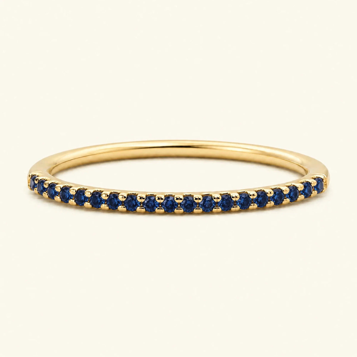 Eternity sapphire ring half-way pavé set in yellow gold