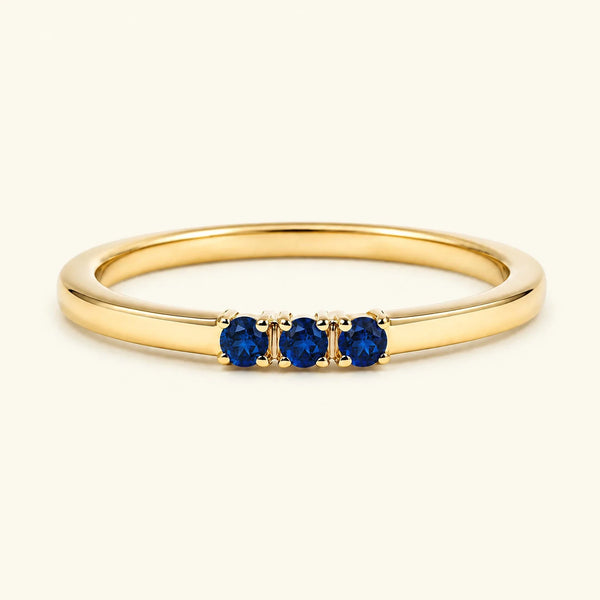 Sapphire trilogy engagement ring in yellow gold