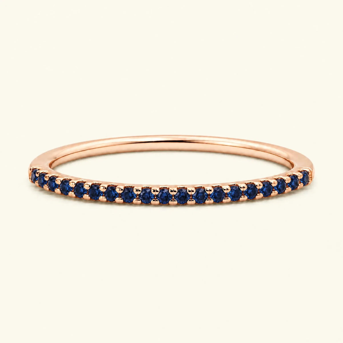 Eternity sapphire ring half-way pavé set in rose gold