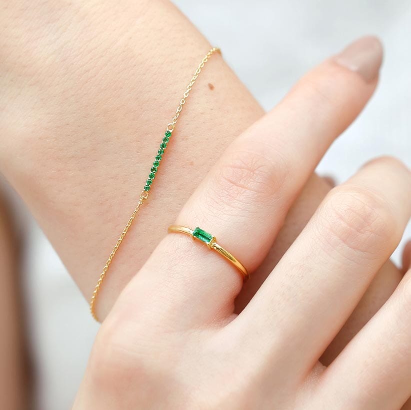 long emerald bar bracelet and emerald baguette ring