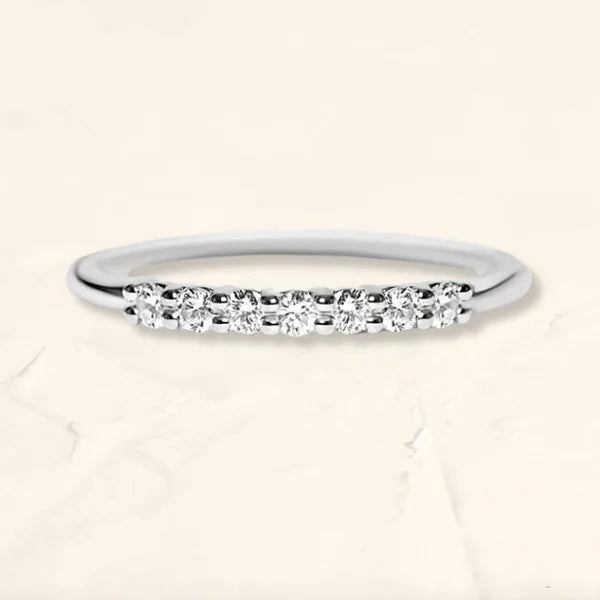 Vadha ring in 18K white gold set with brilliant cut diamonds by Mayuri on beige marble