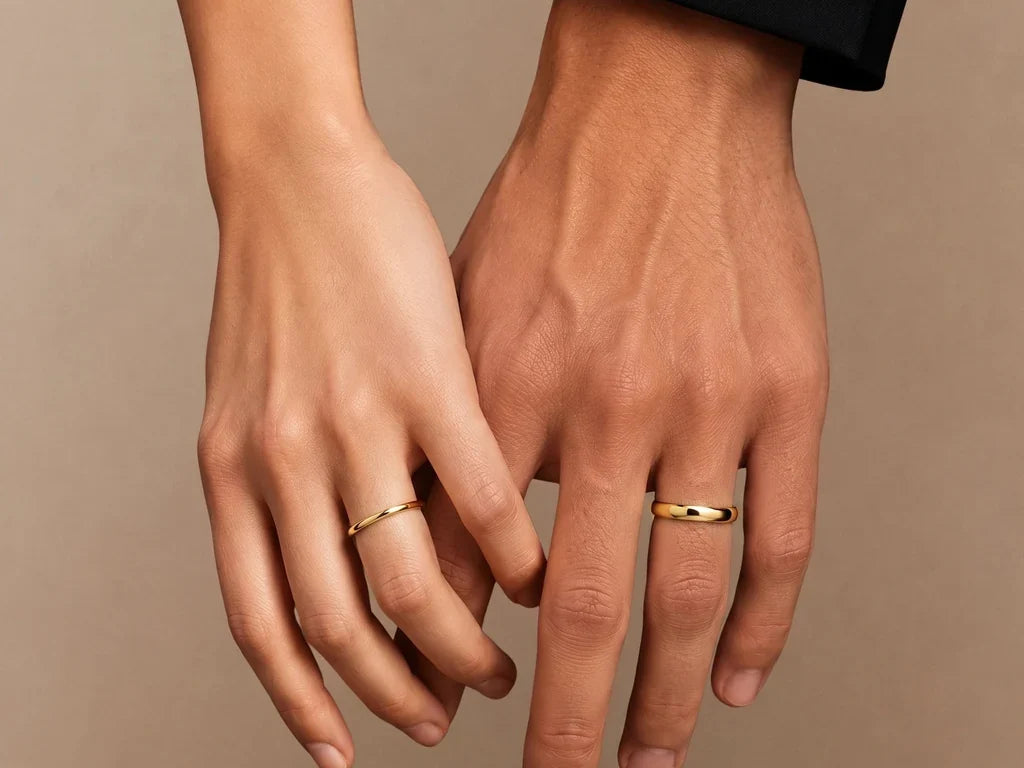 Shunya couple wedding rings in 18K yellow gold, worn on a woman's hand and a man's hand