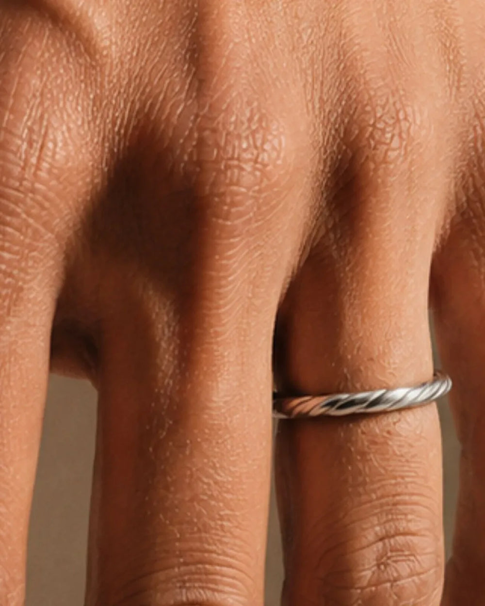 Twisted Vasuki wedding ring in 18K white gold worn on the finger, illustrating the ring size guide