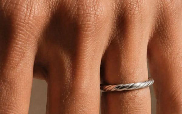 Twisted Vasuki wedding ring in 18K white gold worn on the finger, illustrating the ring size guide