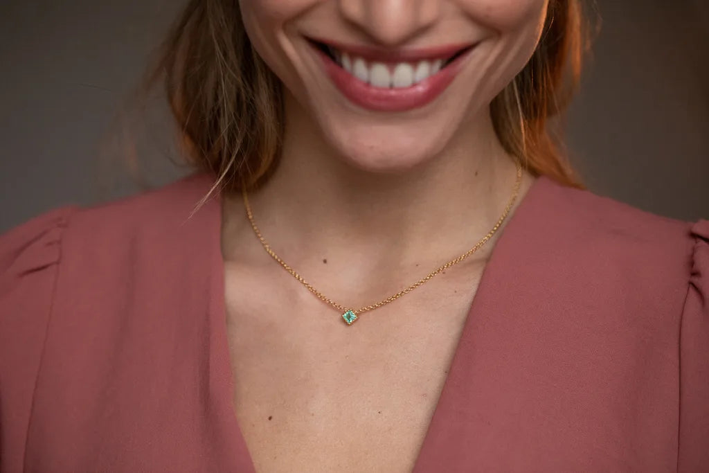 Mayuri's Indrani necklace in 18K yellow gold with an emerald on a delicate chain
