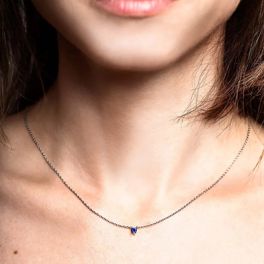 Devi fine necklace in 925 silver with a three-prong set sapphire, worn at the neck