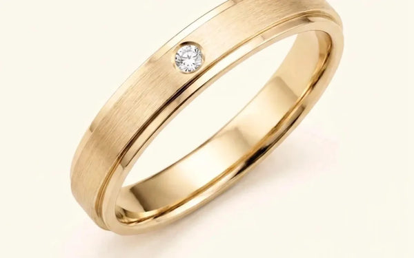 Dhruva wedding ring in 18K yellow gold with a diamond, brushed finish, by Mayuri