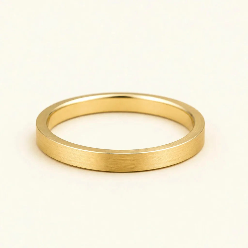 The Kanso wedding ring in 18K yellow gold with a flat, brushed finish by Mayuri