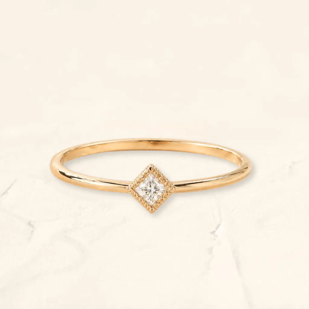 The Indrani ring in 18K yellow gold, set with a princess-cut diamond with milgrain prongs, by Mayuri