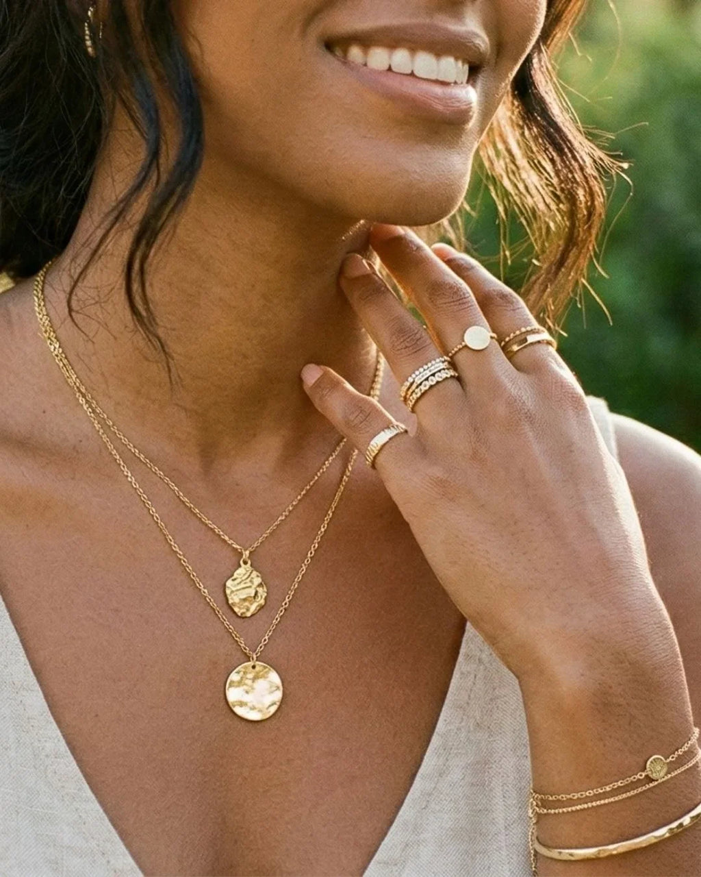 An emerald set in 18K yellow gold worn on golden skin
