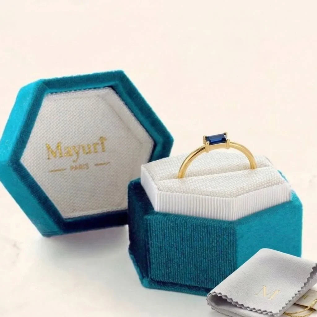 A sapphire ring nestled in a Mayuri velvet jewellery case with a storage pouch