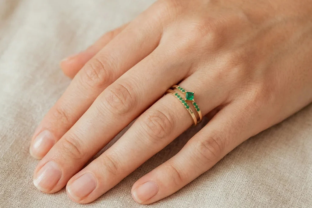 Mayuri solitaire emerald ring in 18K gold worn on the hand