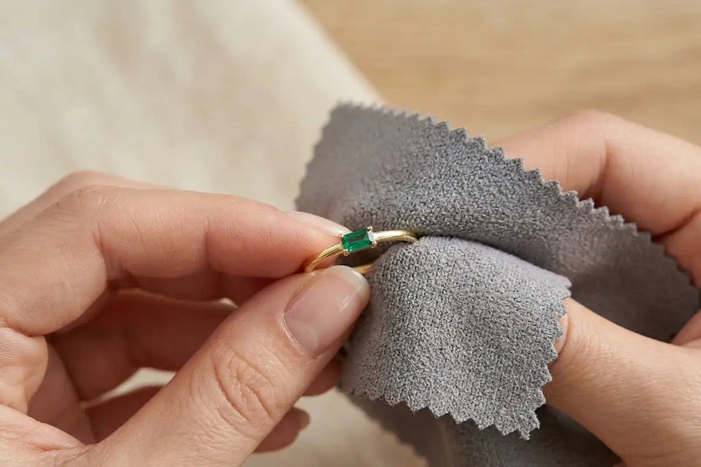 Gentle cleaning of a Mayuri emerald ring with a soft cloth