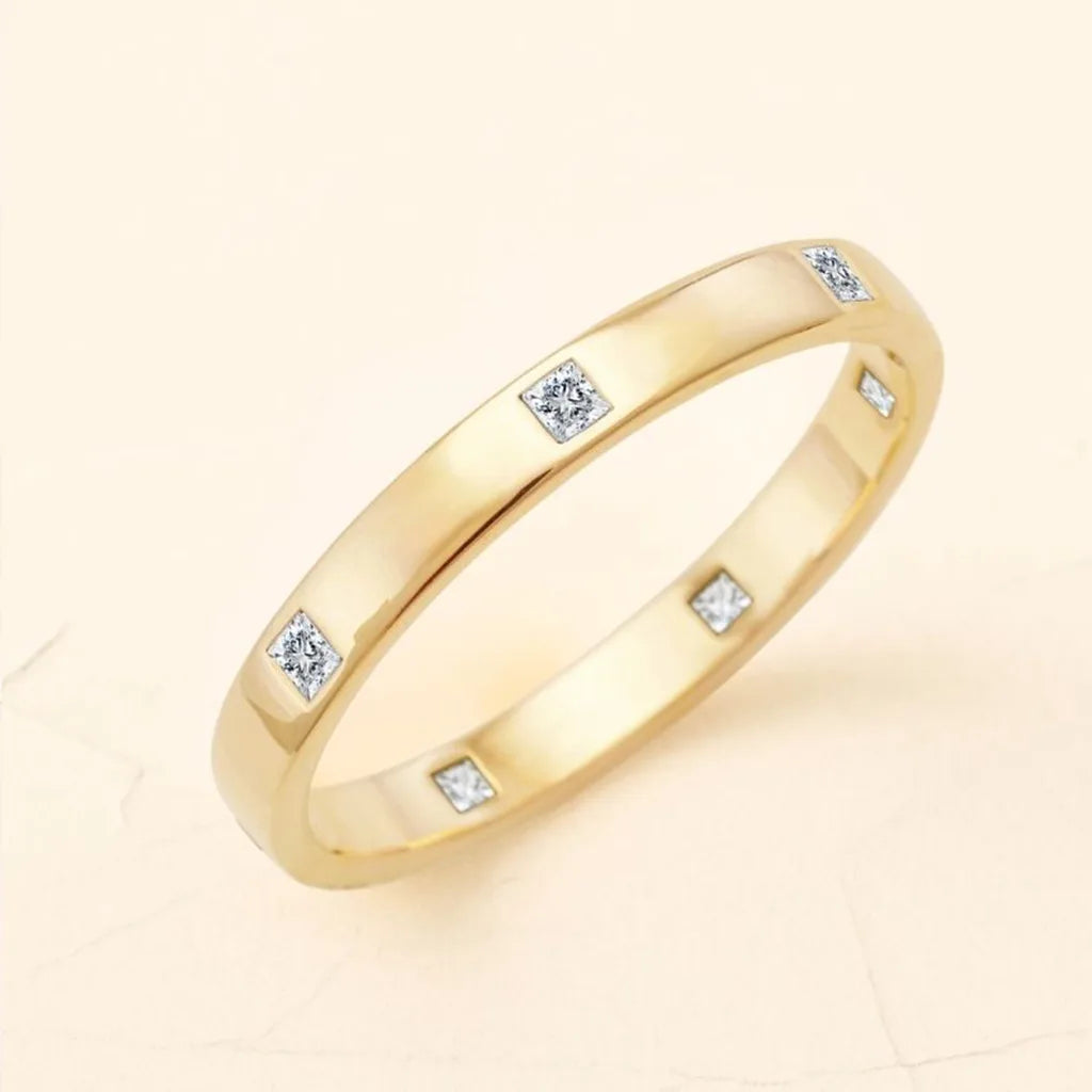Viyom wedding ring in solid 18K yellow gold set with princess cut diamonds, a symbol of lasting investment