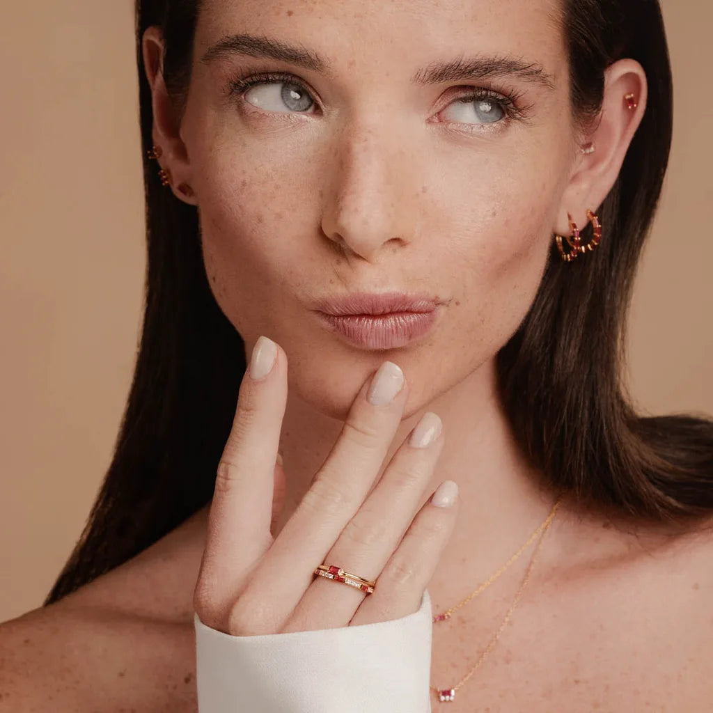 Baguette ruby engagement ring in 18K rose gold worn on the finger, by Mayuri