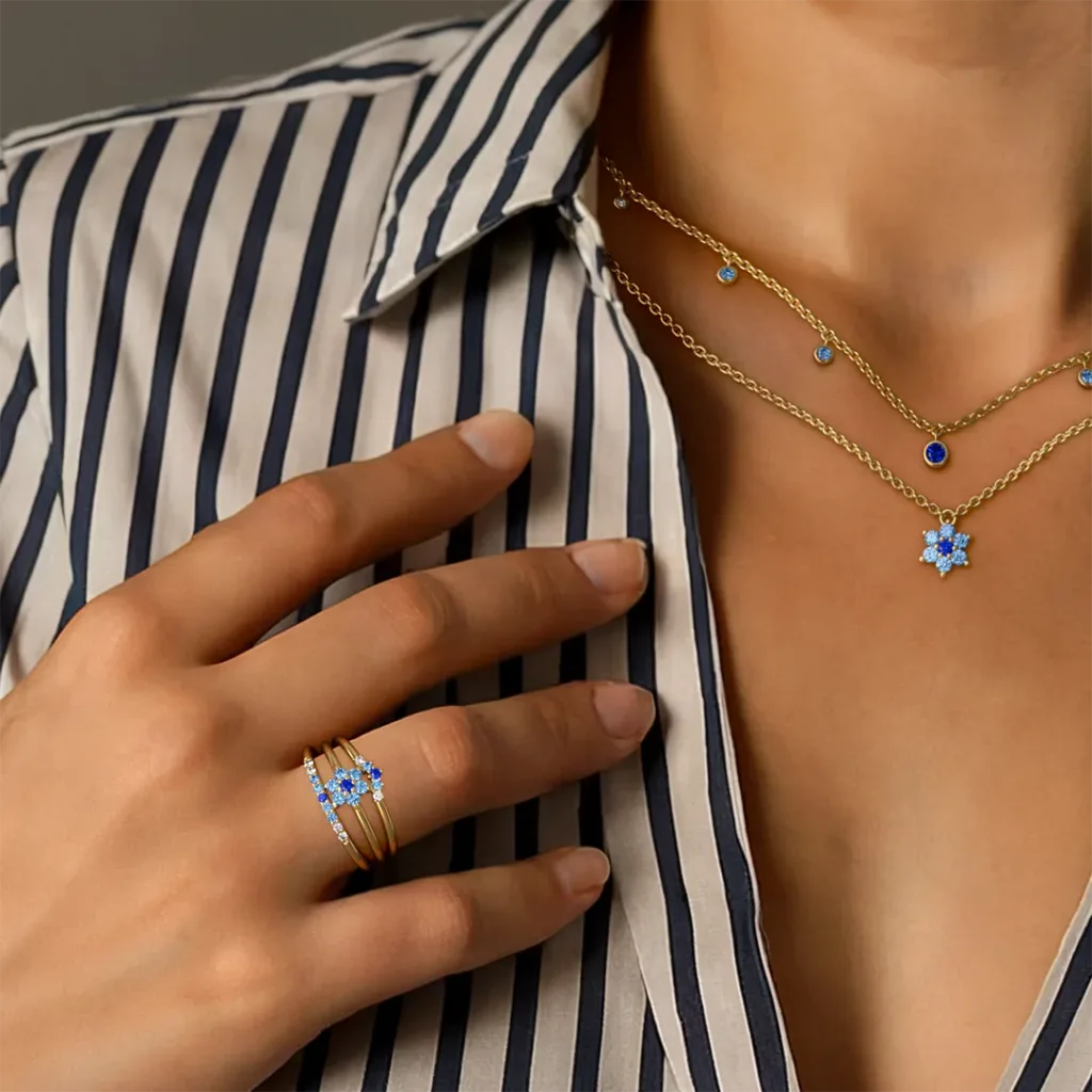 Surya, Anaya and Kiran necklace and rings in 18K yellow gold, Sunset gradient of pink and blue sapphires, worn by Mayuri