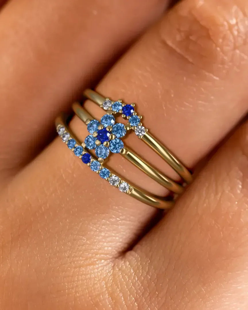 Anaya, Surya and Kiran rings in 18K yellow gold with a Horizon gradient of blue sapphires, worn on the finger by Mayuri