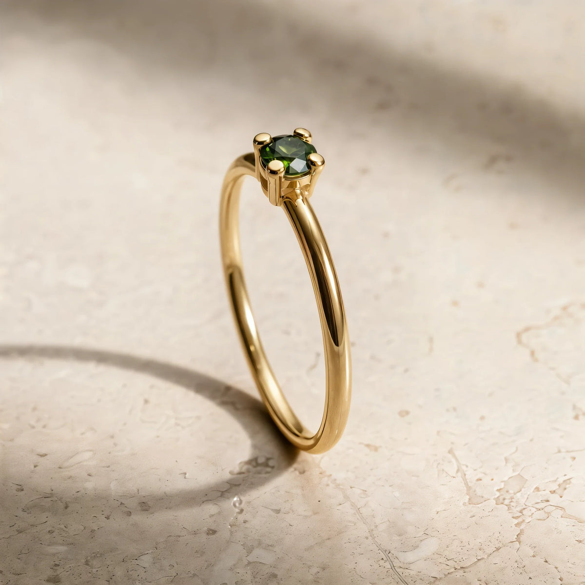 Bague Saral diamant vert en or jaune 18 carats, nature morte sur travertin